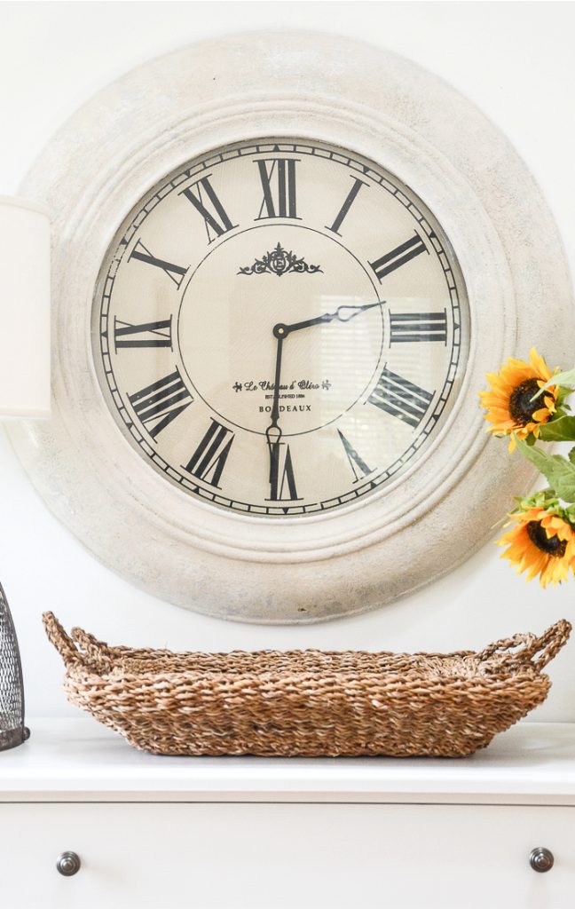 a wall clock that was painted white to give it new life.