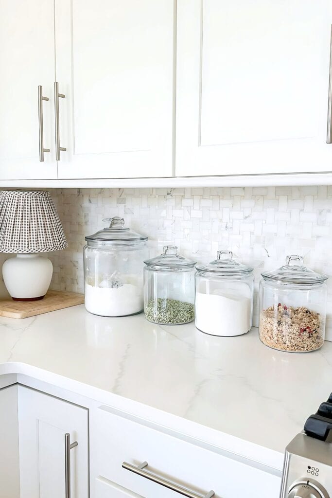 1 DECORATING KITCHEN COUNTERTOPS-1 glass canisters on a white kitchen counter