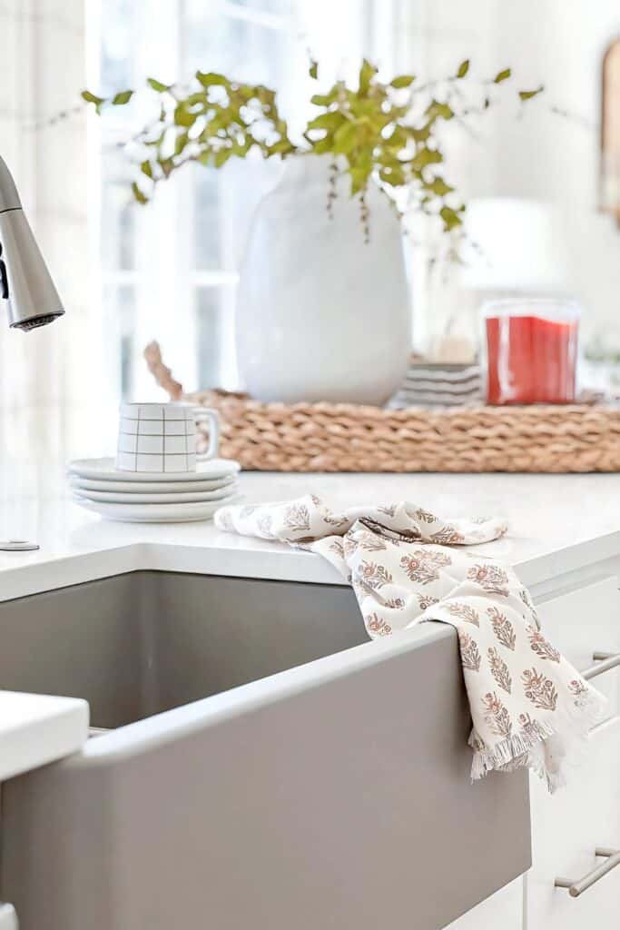 1 DECORATING KITCHEN COUNTERTOPS-dishcloth on the edge of a sink