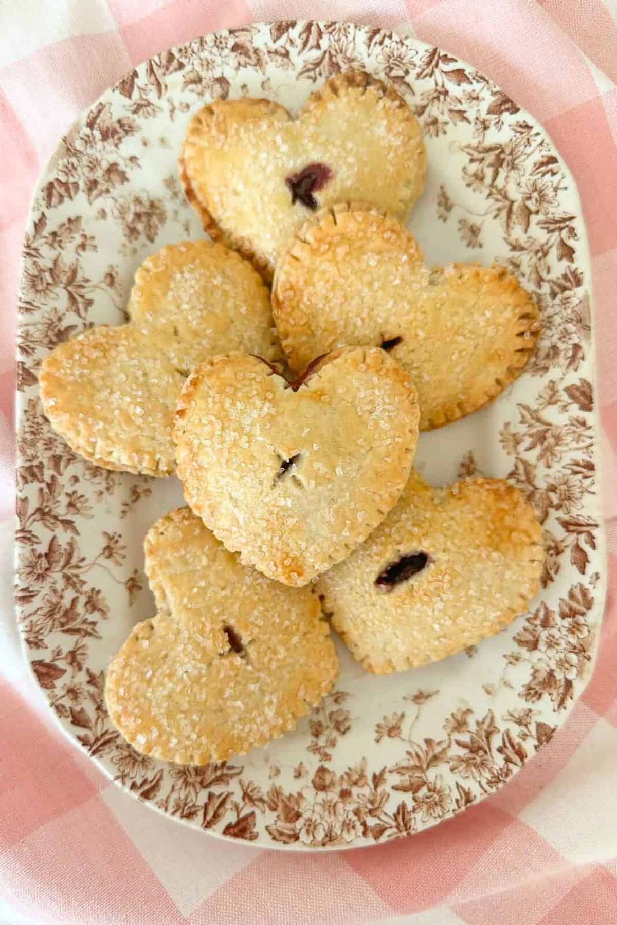 a plate of heart in hand valentine pies