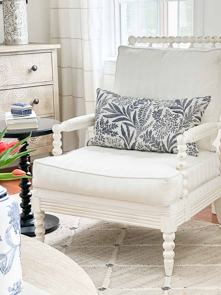 blue and white spring pillow on a white chair