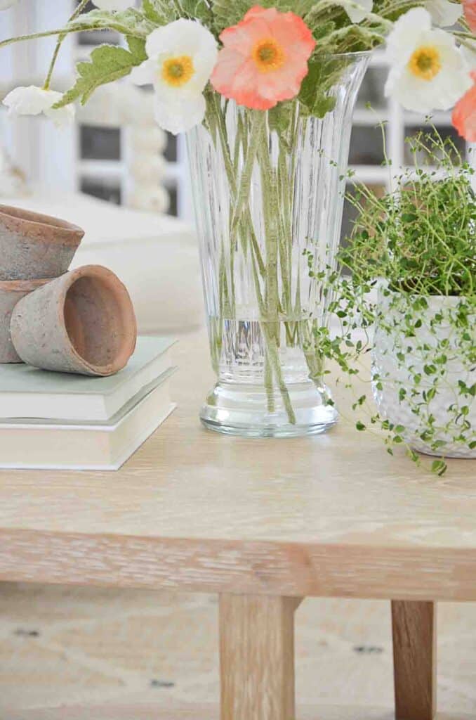 water in a glass vase with faux stems in it