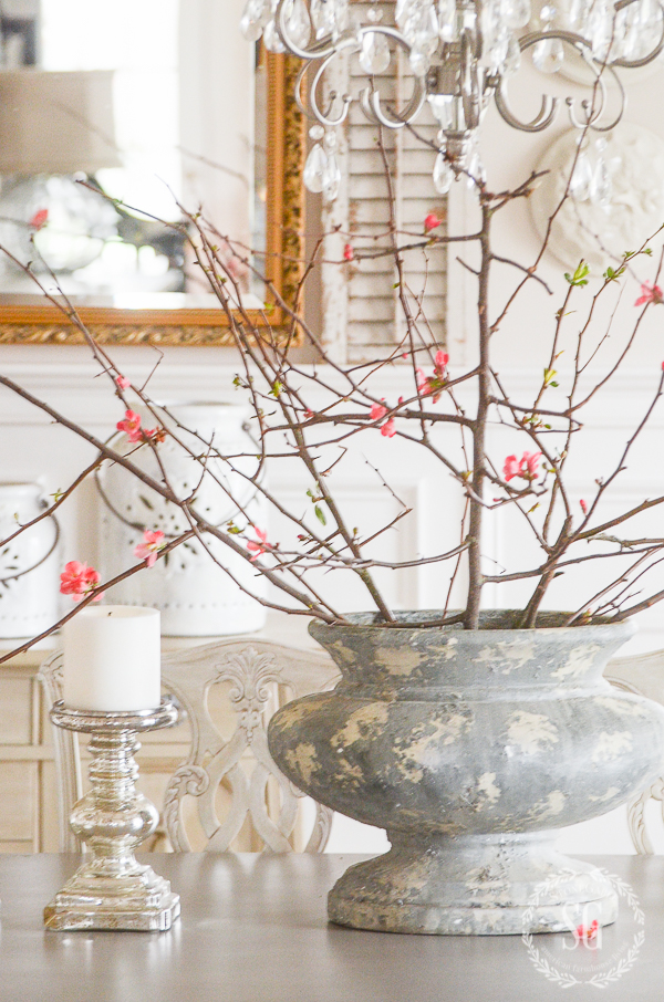 big gray urn filled with flowering crabapple blossoms