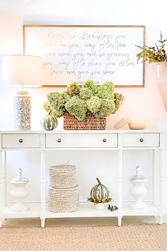 foyer-hydrangeas in a basket with small green pumpkin 