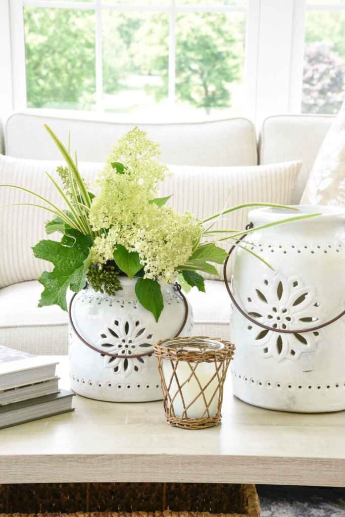 pottery lanterns used as a vase on a coffee table