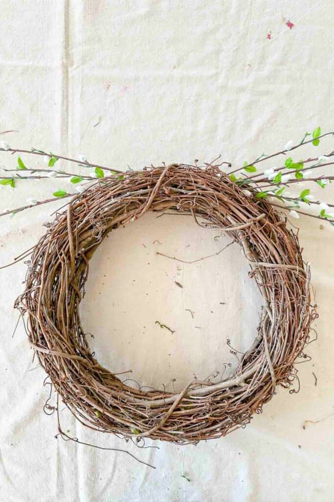 pussy willow brances on the both sides of the wreath