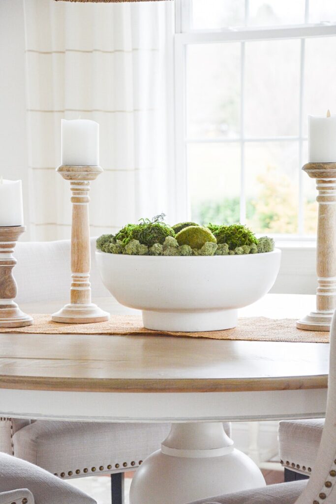 moss in a large white bowl on a dining room table