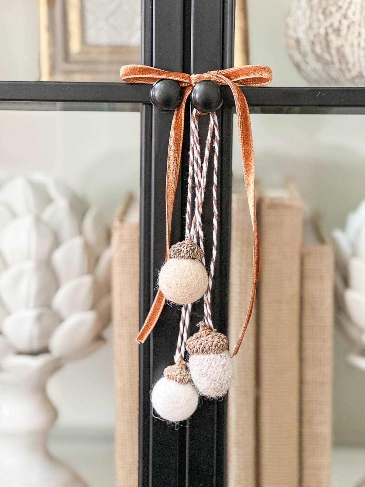 wool fall acorns hanging on an orange ribbon